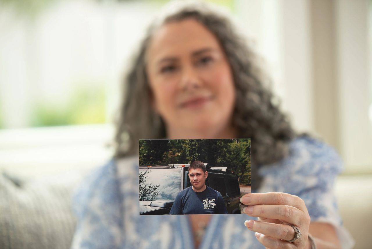 Grief Coach Terri Chaplin holding an image of her son during a branding photoshoot in Brandon, Florida.