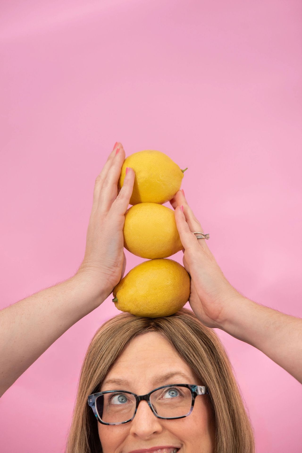 Travel agent, Lisa Harvey, holding lemons during her branding photoshoot in St. Pete, Florida.